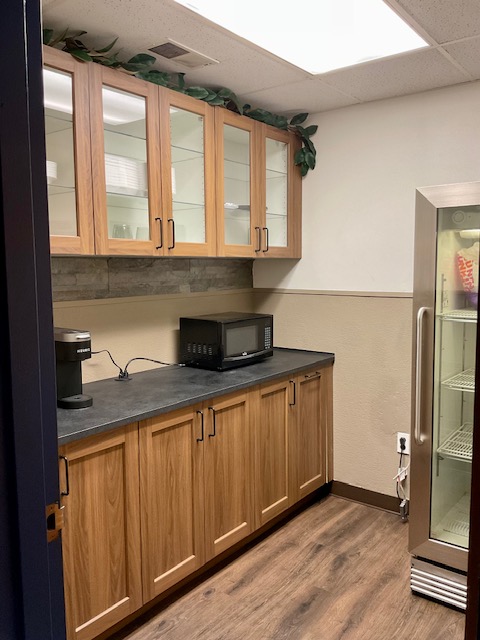 Break room with Keurig coffee maker, microwave, and refrigerator