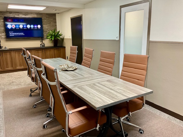 Conference room with meeting table and presentation screen